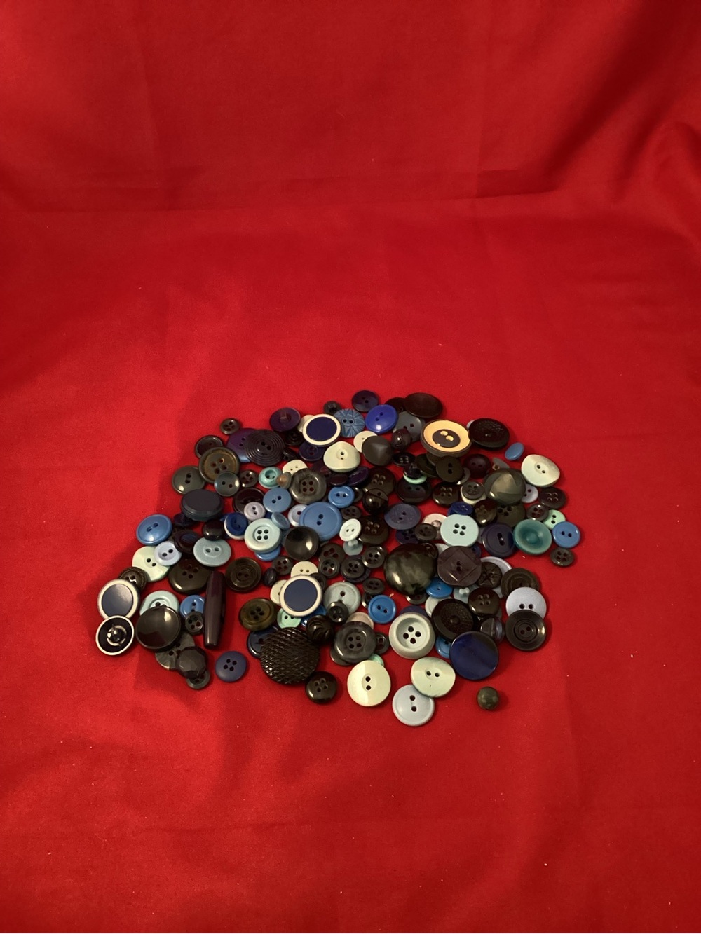 138 grams of Assorted blue Buttons